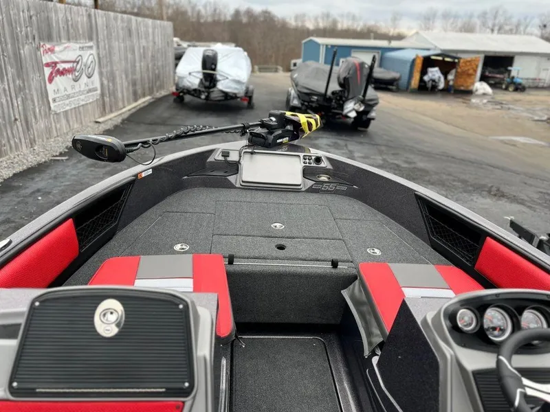 Slide: The Image of 2023 Ranger 1850MS fishing boat with red and gray interior at a boatyard. - 5