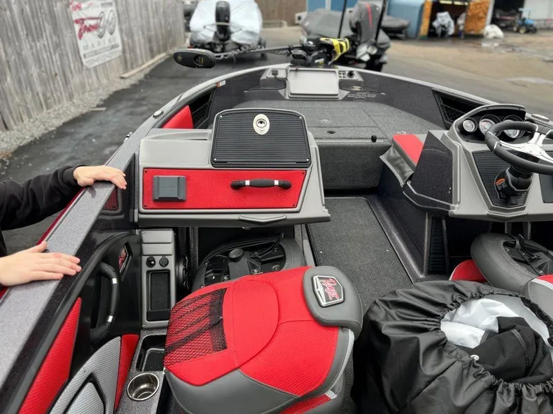 Slide: The Image of 2023 Ranger 1850MS boat interior with red and black seats and dashboard. - 7