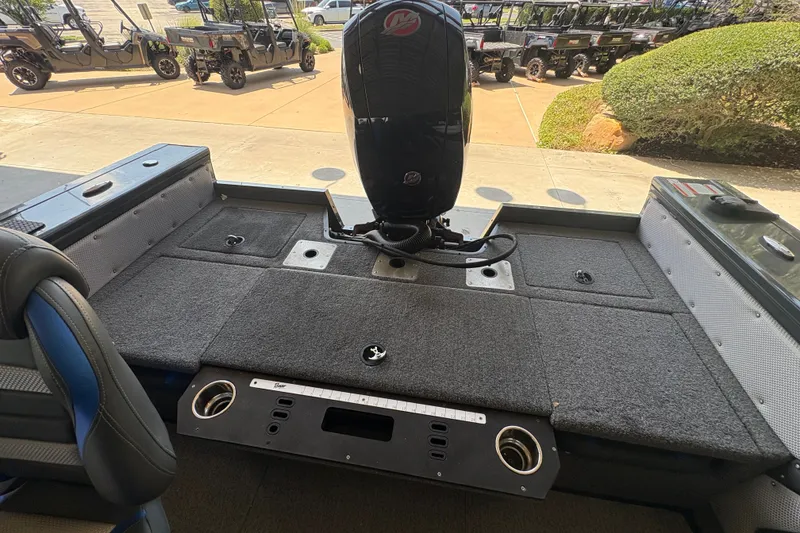 Slide: The Image of 2023 Ranger VX1788 WT boat interior with motor, carpeted deck, and seating. - 26