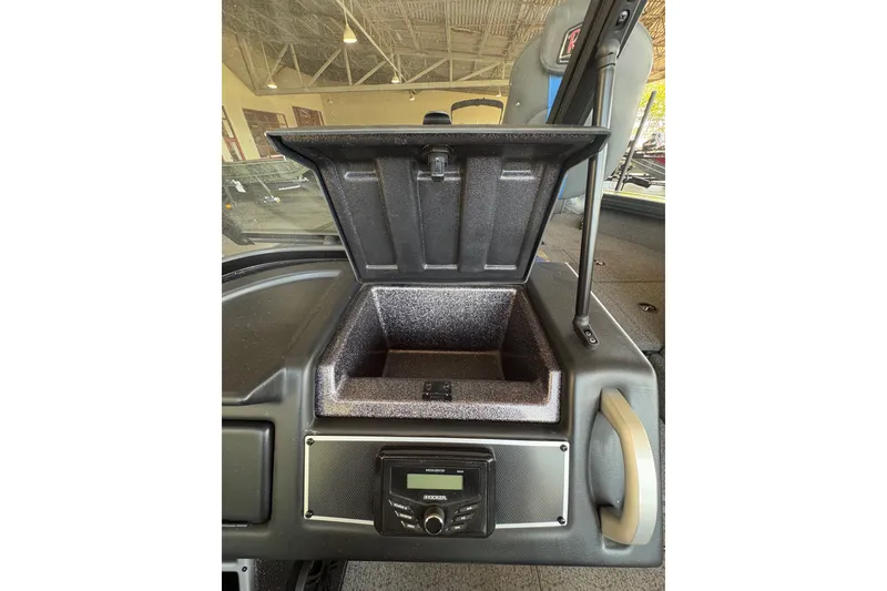 Slide: The Image of 2023 Ranger VX1788 WT boat dashboard with open storage compartment and control panel. - 22