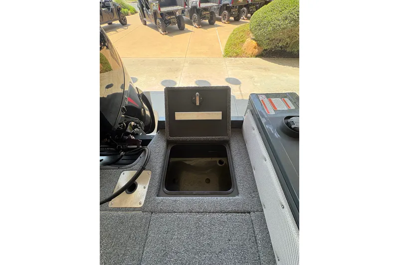 Slide: The Image of 2023 Ranger VX1788 WT boat interior with open storage compartment and motor view. - 30