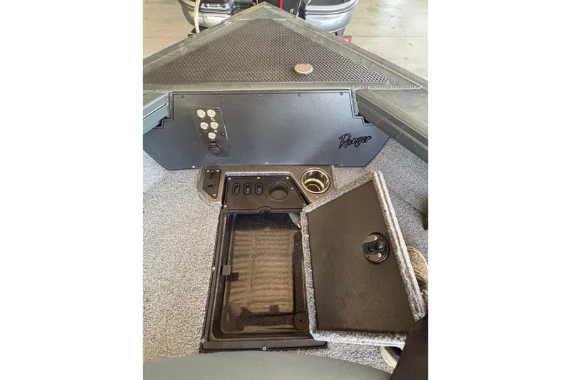 Slide: The Image of 2023 Ranger VX1788 WT boat interior with storage compartment and control panel. - 13