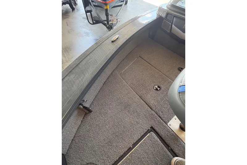 Slide: The Image of 2023 Ranger VX1788 WT boat interior with carpeted flooring and storage compartments. - 11