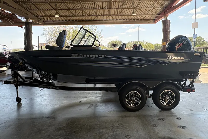 Slide: The Image of 2023 Ranger VX1788 WT boat on trailer in covered area, side view. - 2