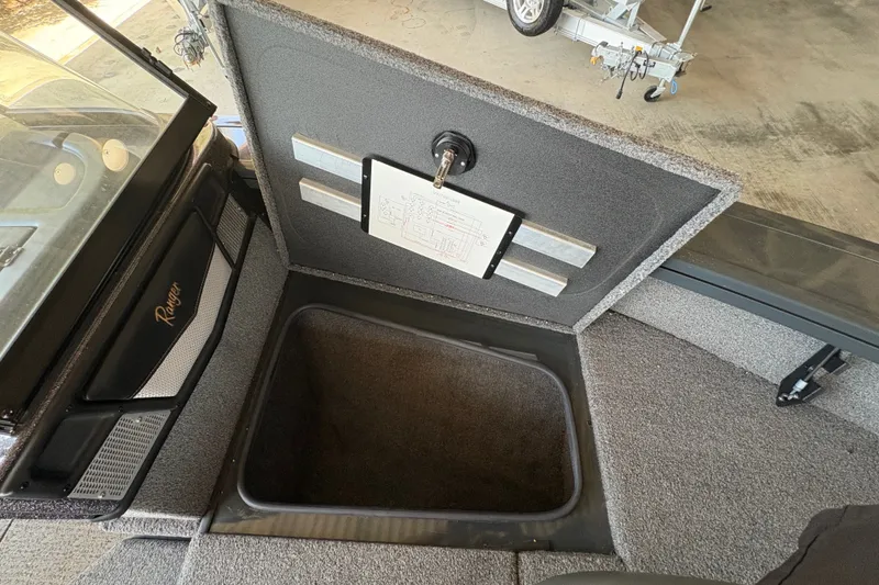 Slide: The Image of 2023 Ranger VX1788 WT boat storage compartment with open lid, showcasing interior space. - 14
