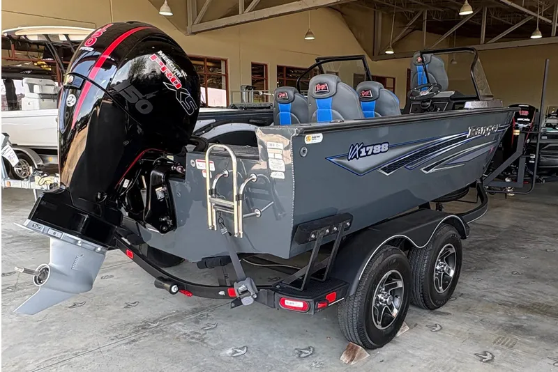 Slide: The Image of 2023 Ranger VX1788 WT boat in showroom, featuring powerful outboard motor and sleek design. - 5