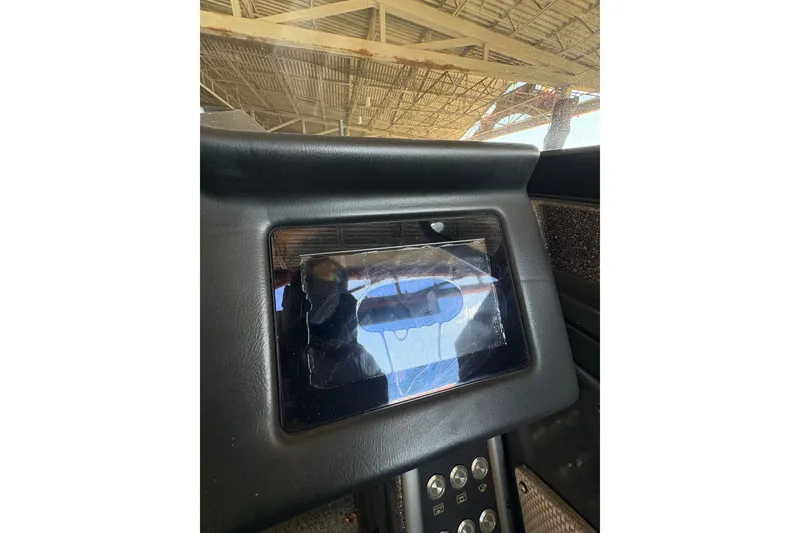 Slide: The Image of 2023 Ranger VX1788 WT dashboard with a protective screen cover under a metal roof. - 32
