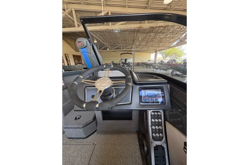Slide: The Image of 2023 Ranger VX1788 WT boat dashboard with steering wheel and digital display. - 18