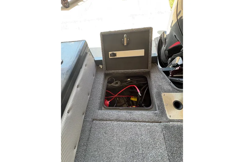 Slide: The Image of 2023 Ranger VX1788 WT boat battery compartment with open hatch and visible wiring. - 31
