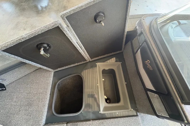Slide: The Image of 2023 Ranger VX1788 WT boat storage compartments with open lids, showcasing interior design. - 15