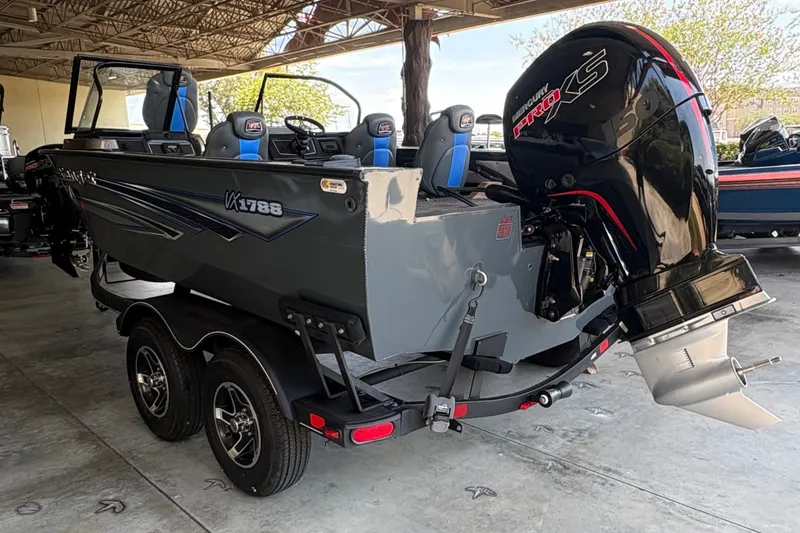 Slide: The Image of 2023 Ranger VX1788 WT boat with powerful outboard motor in a covered storage area. - 3