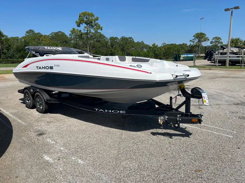 The Image of 2023 Tahoe 2150 boat on trailer in parking lot, sunny day. - 0