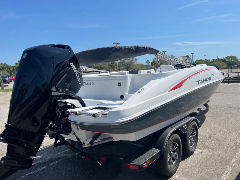 Slide: The Image of 2023 Tahoe 2150 boat on trailer, featuring sleek design and powerful outboard motor. - 3