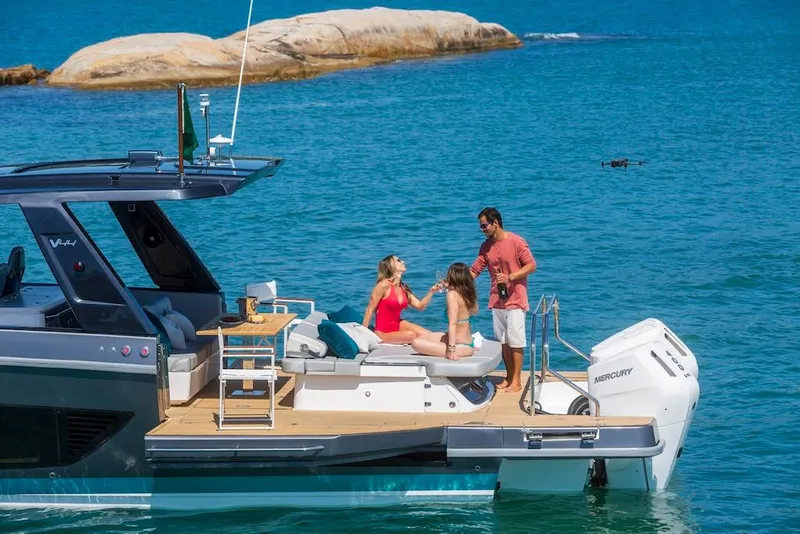 Slide: The Image of People enjoying on a 2025 Schaefer V44 yacht in clear blue waters. - 10