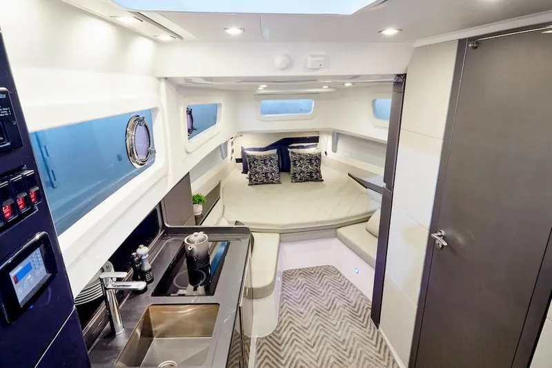 Slide: The Image of Luxurious interior of 2025 Schaefer V44 yacht with modern kitchen and cozy seating area. - 19