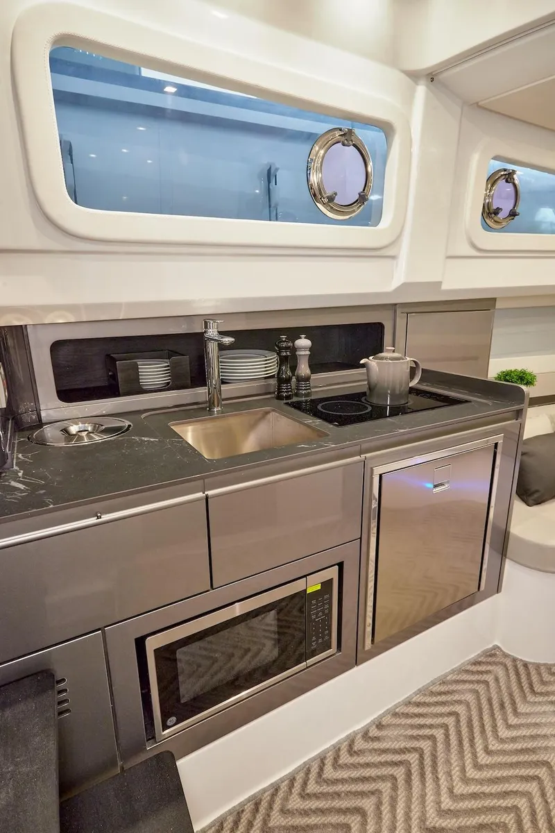 Slide: The Image of Modern kitchen in 2025 Schaefer V44 yacht with sink, microwave, and stove. - 21