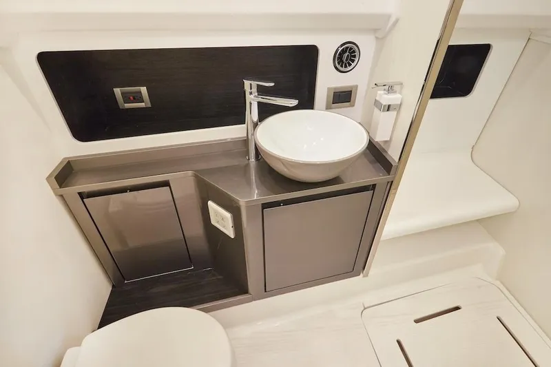 Slide: The Image of Modern bathroom interior of Schaefer V44 yacht, 2025 model, featuring sleek sink and cabinetry. - 25