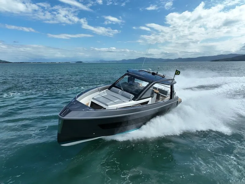 Slide: The Image of Schaefer V44 2025 luxury yacht cruising on open water under a clear blue sky. - 1