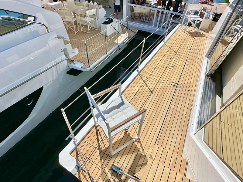 Slide: The Image of Luxury Schaefer 770 yacht, 2025 model, featuring spacious teak deck and modern seating. - 12