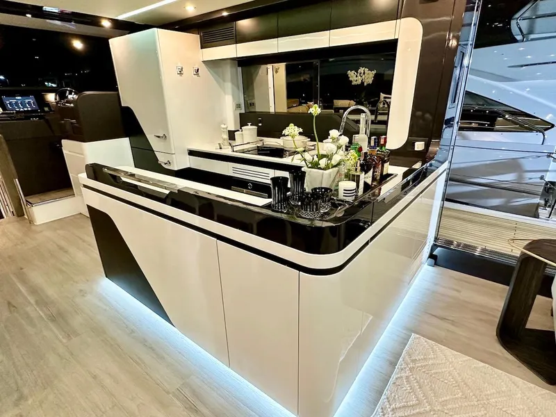 Slide: The Image of Modern kitchen interior on Schaefer 770 yacht, 2025 model, with sleek black and white design. - 21