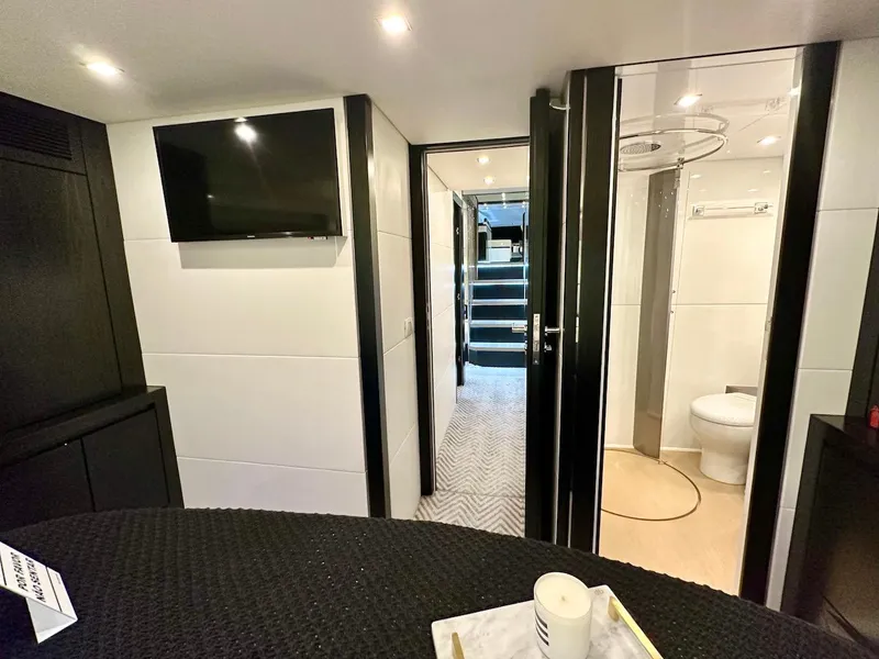 Slide: The Image of Modern interior of Schaefer 770 yacht, featuring a TV, bathroom, and stairs, 2025 model. - 33