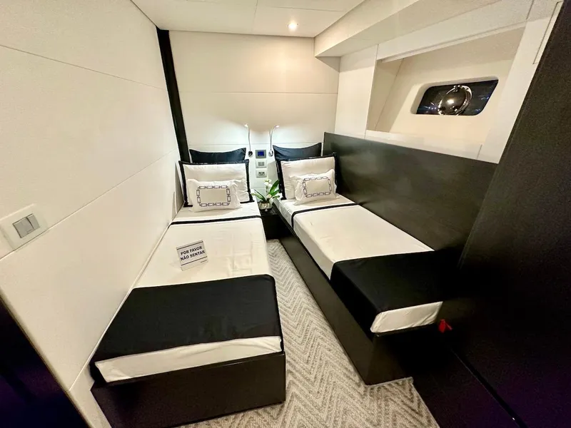 Slide: The Image of Modern twin bedroom in 2025 Schaefer 770 yacht with sleek black and white decor. - 35