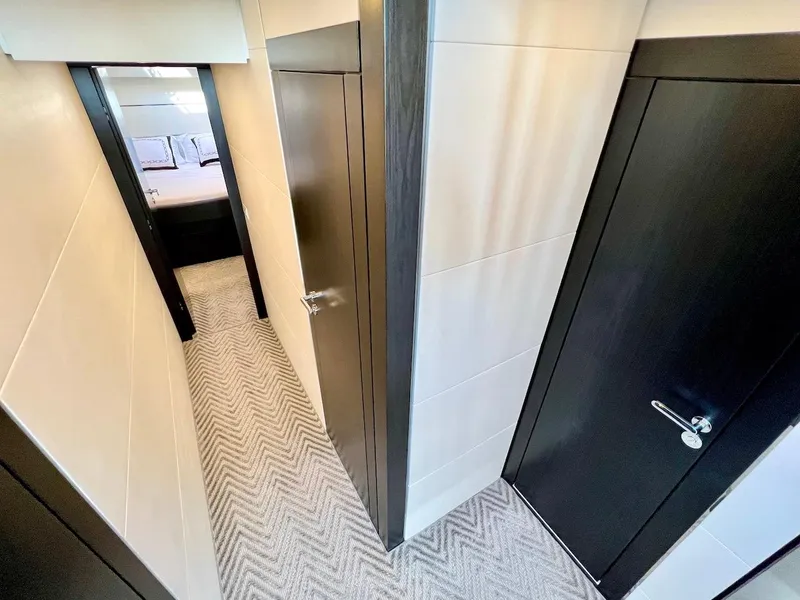 Slide: The Image of Narrow hallway in Schaefer 770 yacht, 2025 model, leading to a bedroom. - 36