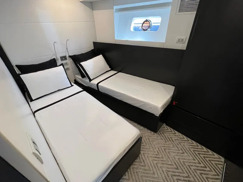 Slide: The Image of Modern twin cabin interior of Schaefer 770 yacht, 2025 model, with sleek black and white decor. - 39