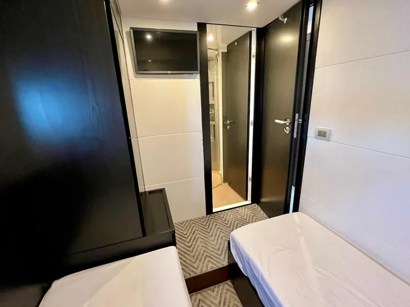 Slide: The Image of Modern cabin interior of Schaefer 770 yacht, featuring twin beds and a wall-mounted TV. - 40