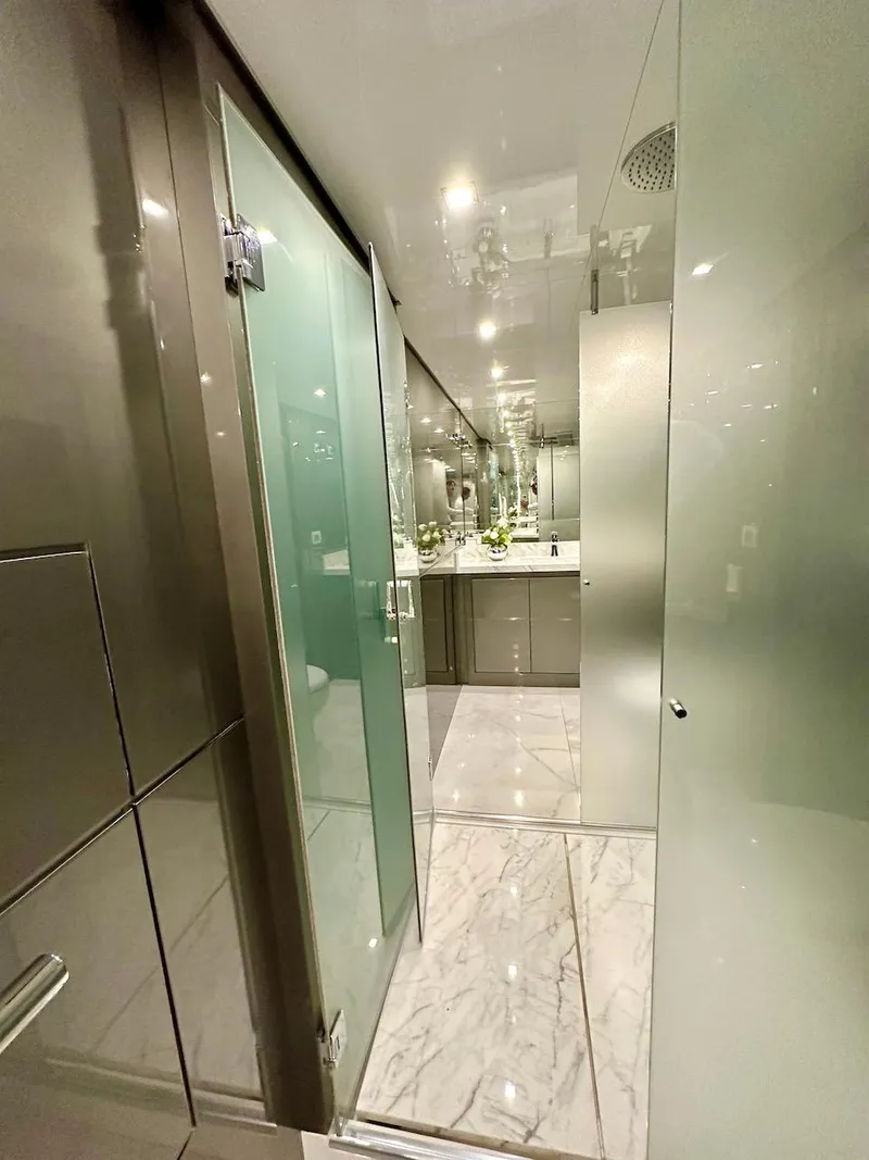 Slide: The Image of Modern bathroom with glass doors, marble flooring, and sleek fixtures in a 2025 Schaefer 770 yacht. - 48