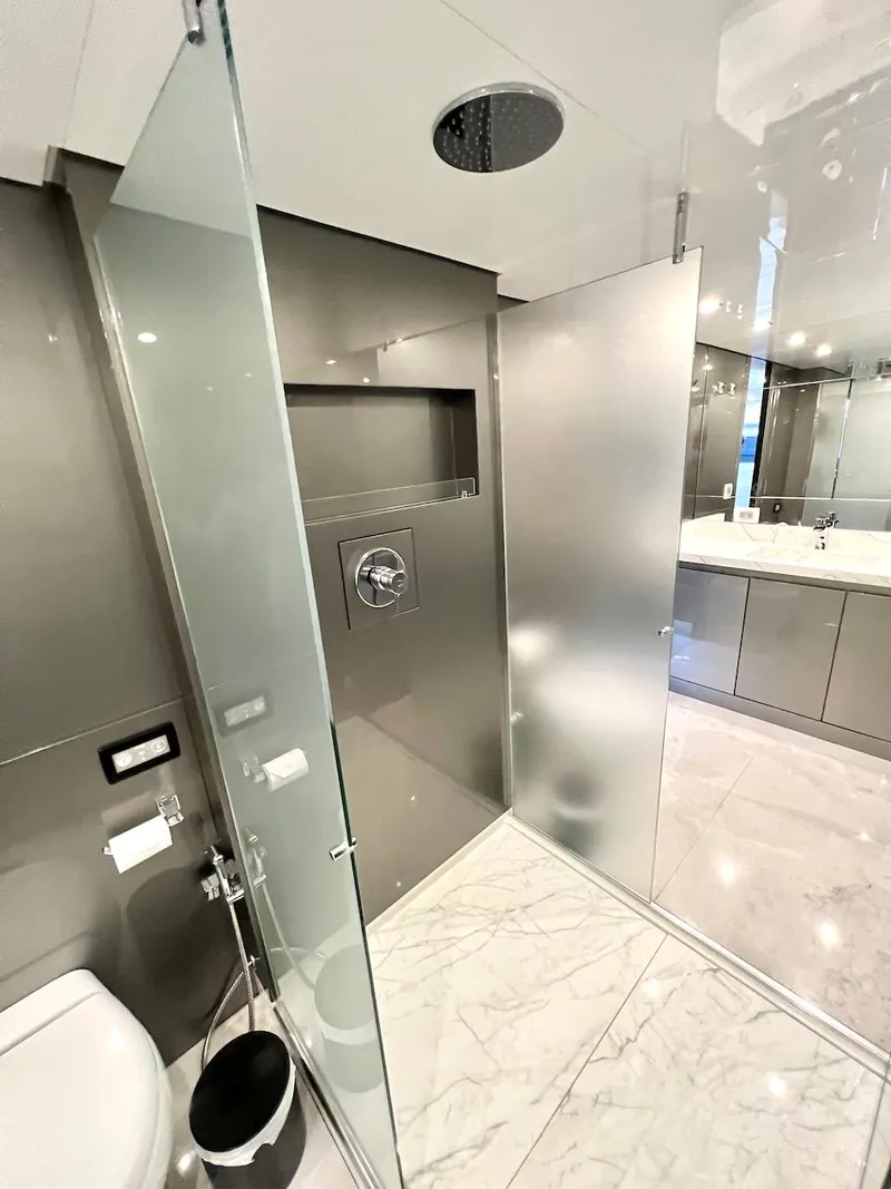 Slide: The Image of Modern bathroom in Schaefer 770 yacht, 2025 model, featuring glass shower and marble flooring. - 49