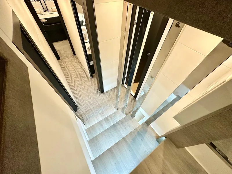 Slide: The Image of Interior staircase of 2025 Schaefer 770 yacht with modern design and sleek finishes. - 30