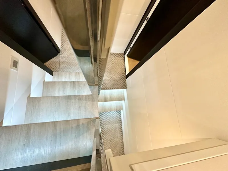 Slide: The Image of Modern staircase in Schaefer 770 yacht, 2025 model, featuring sleek design and wood steps. - 42