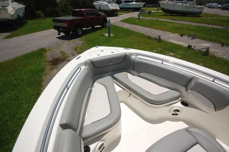 Slide: The Image of 2021 NauticStar 2102 Legacy boat with spacious seating in a marina. - 10