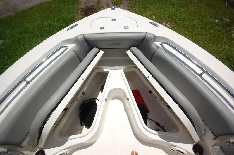 Slide: The Image of 2021 NauticStar 2102 Legacy boat bow storage compartments and seating. - 12