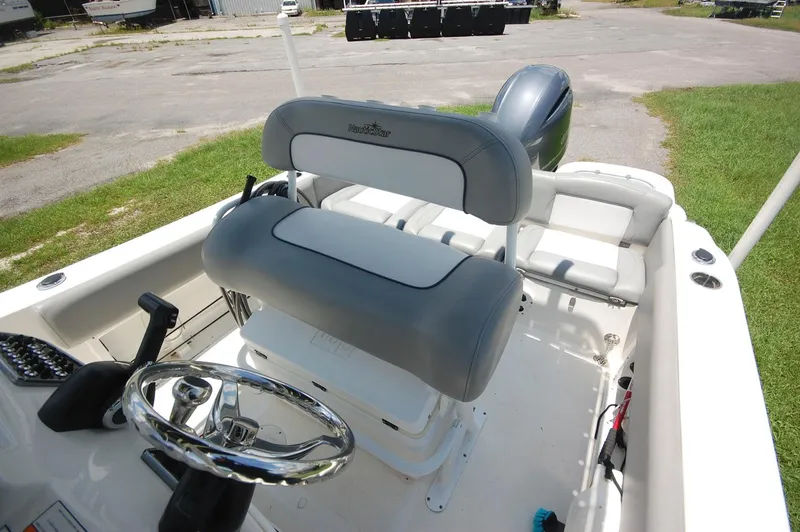 Slide: The Image of 2021 NauticStar 2102 Legacy boat interior with dual seating and steering wheel. - 14