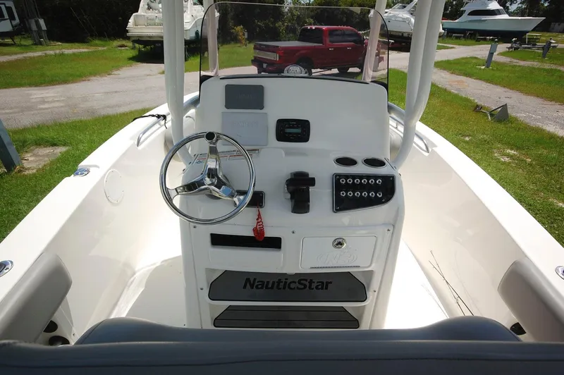 Slide: The Image of 2021 NauticStar 2102 Legacy boat console with steering wheel and control panel. - 15