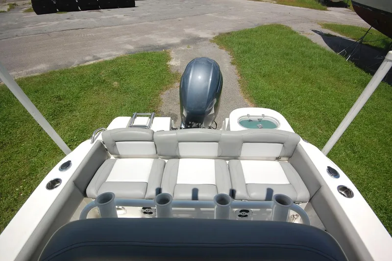 Slide: The Image of 2021 NauticStar 2102 Legacy boat with rear seating and outboard motor. - 17