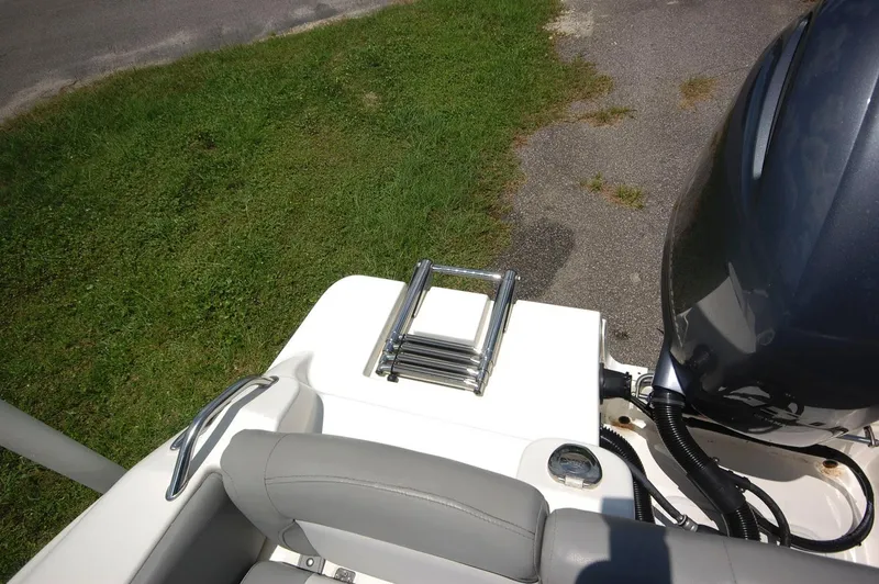 Slide: The Image of 2021 NauticStar 2102 Legacy boat with ladder and outboard motor. - 20