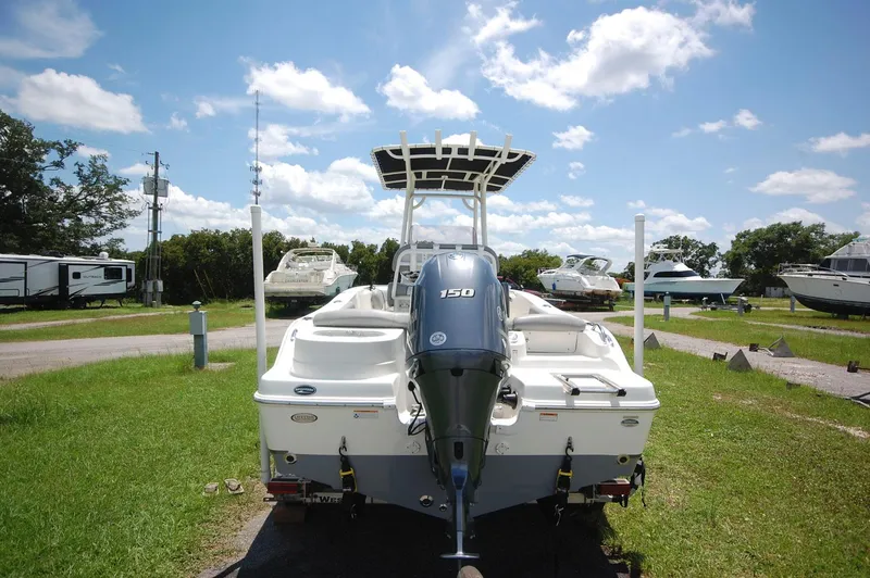 Slide: The Image of 2021 NauticStar 2102 Legacy boat with Yamaha 150 engine, parked on grass. - 21