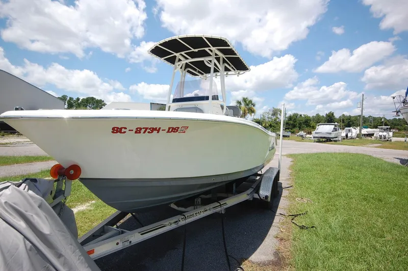 Slide: The Image of 2021 NauticStar 2102 Legacy boat on trailer under blue sky. - 7