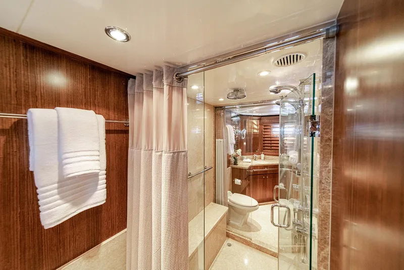 Slide: The Image of Luxurious bathroom on 2007 Hargrave 78 Open Bridge yacht with glass shower and elegant wood finishes. - 25