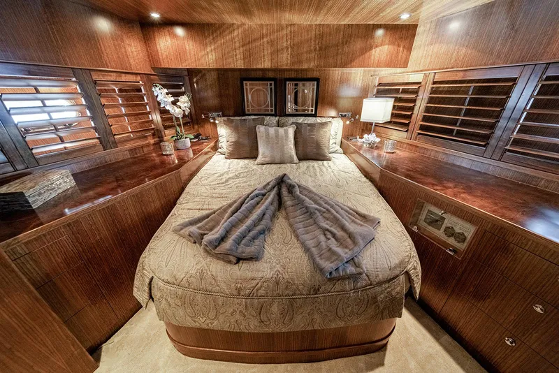 Slide: The Image of Luxurious bedroom interior on 2007 Hargrave 78 Open Bridge yacht, featuring elegant wood finishes. - 28