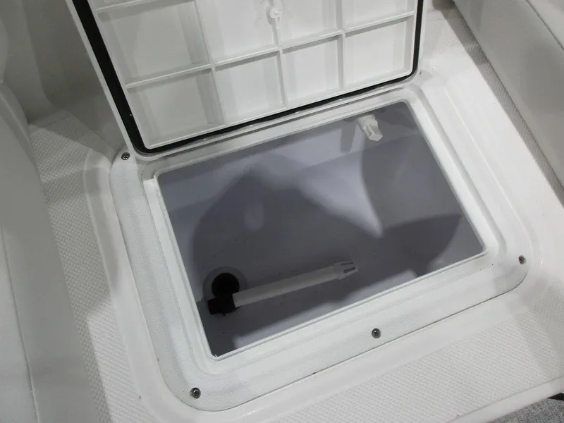Slide: The Image of 2023 Hurricane SunDeck 187 IO storage compartment, open lid, white interior. - 16