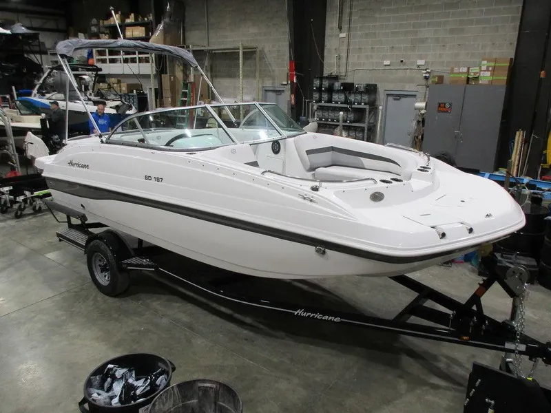 Slide: The Image of 2023 Hurricane SunDeck 187 IO boat on trailer in a warehouse setting. - 3