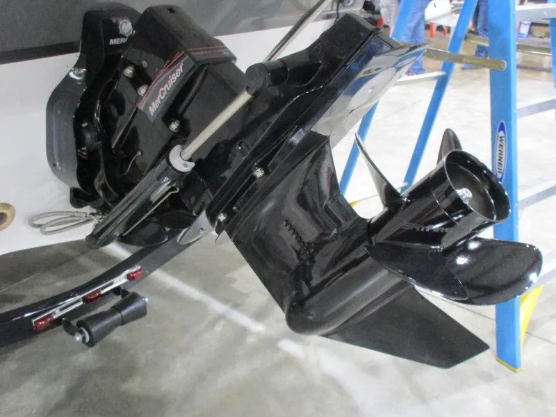 Slide: The Image of 2023 Hurricane SunDeck 187 IO boat engine and propeller detail in a workshop setting. - 6