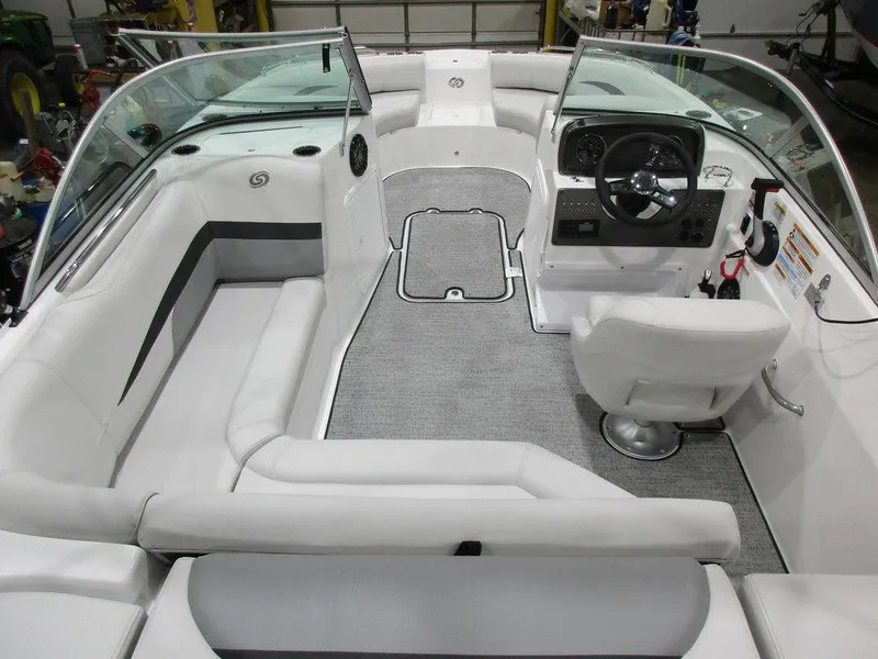 Slide: The Image of 2023 Hurricane SunDeck 187 IO boat interior with white seating and modern dashboard. - 9