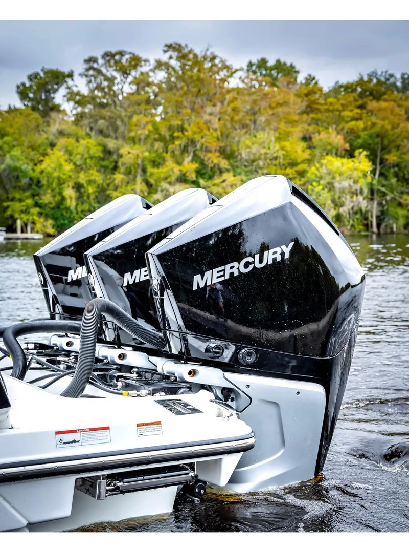 Slide: The Image of 2022 Monterey 38 Super Sport with triple Mercury outboard engines on a lake. - 3