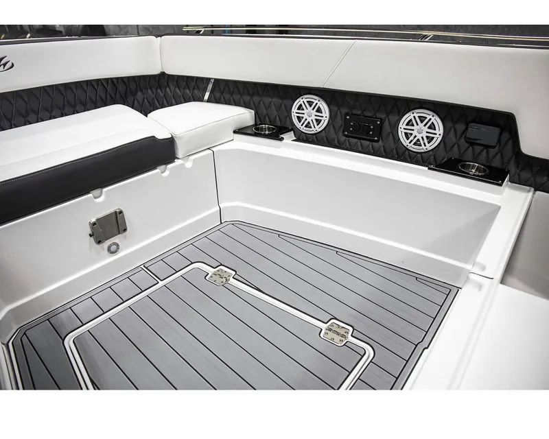 Slide: The Image of 2022 Monterey 38 Super Sport boat interior with cushioned seating and marine speakers. - 6