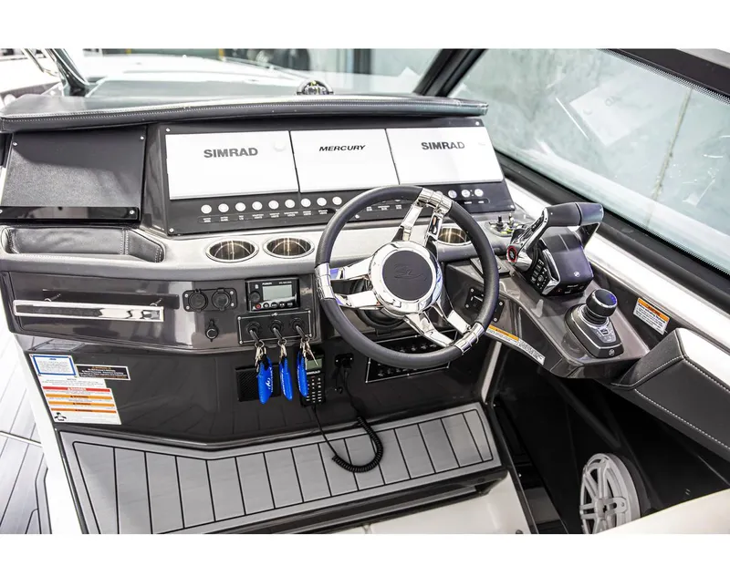 Slide: The Image of 2022 Monterey 38 Super Sport boat dashboard with Simrad and Mercury controls. - 7